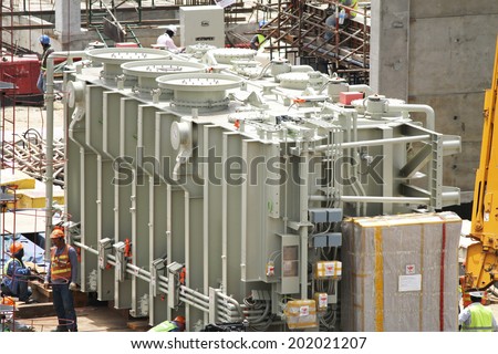 NONTHABURI -THAILAND - JUNE 24 : Construction of EGAT\'s North Bangkok gas combine cycle power plant 800 MW, transformer loading on June 24, 2014 in Nonthaburi, Thailand