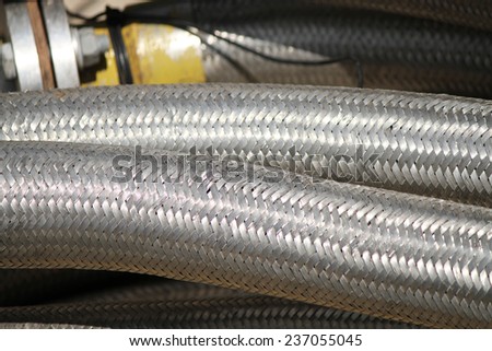 Flexible oil hose with steel wire casing.