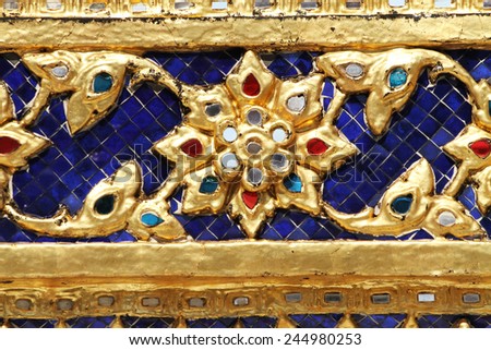 Pieces of multicolored ceramic and colored mirror tiles decorated on temple in Wat Phra Kaew, Bangkok, Thailand