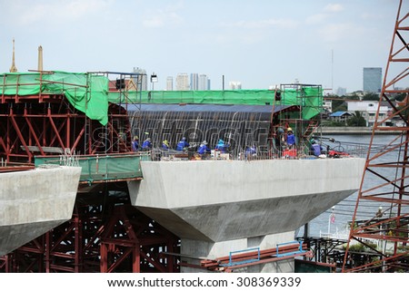 AUGUST 9, 2015 ; NONTHABURI - THAILAND : Detail construction of Concrete bridge across Chaopraya river under-construction of its foundation, road surface and its supporting structure.