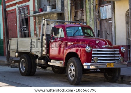 HAVANA -  NOV 4: Vintage truck parked on a deserted street on the background of old houses on November  4,2012 in Havana.