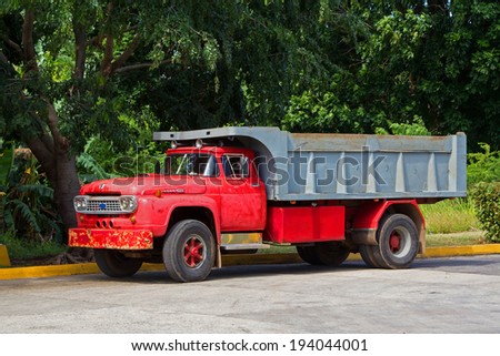 Havana, Cuba - November 3, 2012: Vintage truck parked on the street on the background trees
