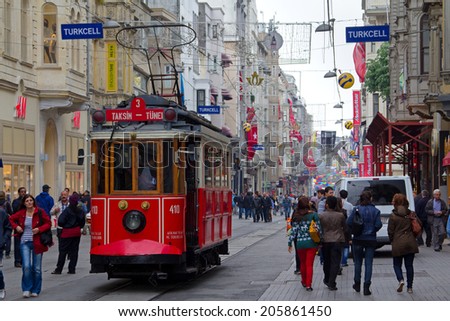 ISTANBUL, TURKEY - APRIL 25, 2014: Retro tram moves along a busy Istiklal street in Istambul.