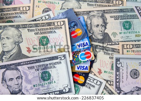 KIROV, RUSSIA - OCTOBER 25, 2014: Photo of VISA and Mastercard credit card with USA dollars bills