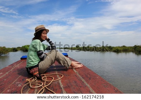 Beautiful woman sitting on the long boat