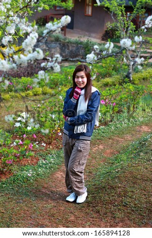 Portrait of a beautiful Asian woman with cherry blossoms.(Doi Aung Khang Mountain)