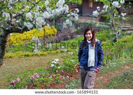Portrait of a beautiful Asian woman with cherry blossoms.