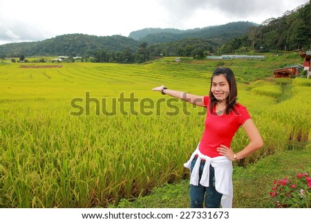 Beautiful tourism young woman in the green rice fields meadow