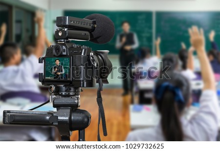 Professional digital Mirrorless camera with microphone on the tripod recording video blog of Asian teacher in the classroom,Camera for photographer or Video and Technology Live Streaming concept