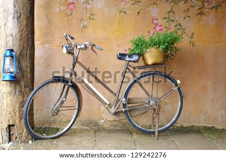 classic bicycle in front of art wall background