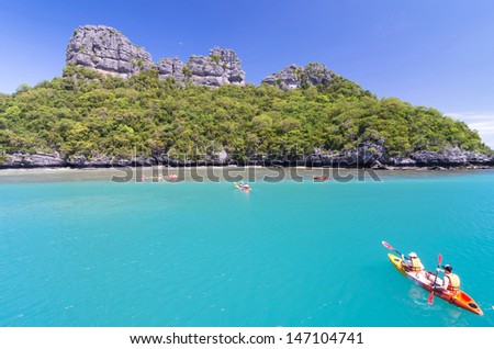 KOH SAMUI, THAILAND - JUNE 29 : two undefined traveler are padding a kayak to the traveler group in front of the island on June 29, 2013. Koh Samui is the third largest island of Thailand.