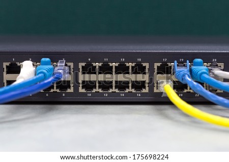 part of Network switch 24 ports with LAN cable on the office table, Front view version