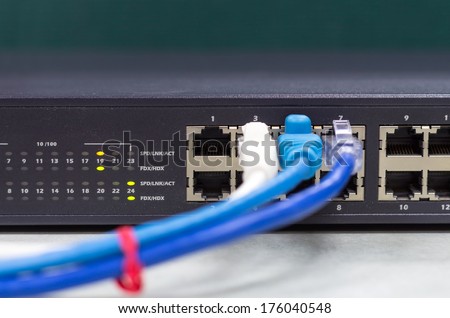 part of Network switch with LAN cable on the office table, Front view version