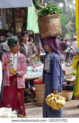 BAGAN, MYANMAR- JAN 4: An unidentified Burmese woman carrying the basket of vegetable on the head in market at bagan, Myanmar on January 4, 2011. carrying by head is Burmese traditional at myanmar