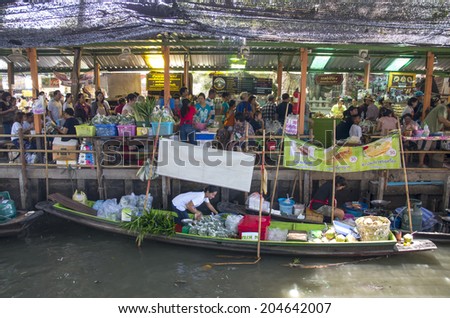 BANGKOK - JULY 06: Merchant and customer on Wooden boats at Klong Lat Mayom Float Market on April 19, 2014 in Bangkok. A traditional popular method still practiced in float market canals of Thailand.