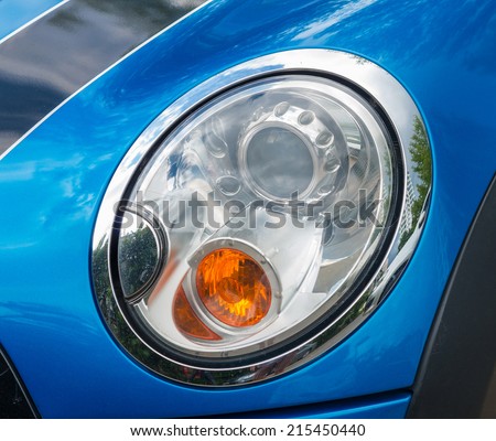 Detail on the headlight of a blue car