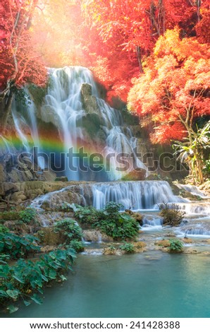 Beautiful waterfall with soft focus and rainbow in the forest