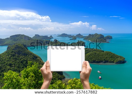 Female hands holding tablet taking pictures Top view of Ang Thong National Marine Park, Thailand