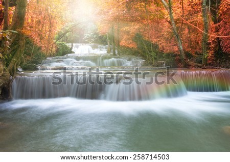Beautiful waterfall in soft focus with rainbow in the forest