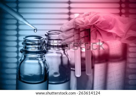 Chemical Laboratory,scientist dropping the reagent into test flask