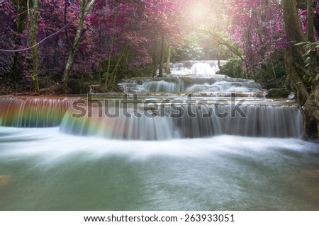 Beautiful waterfall in soft focus with rainbow in the forest