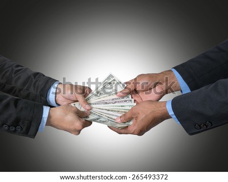 Businessman receiving the money offered by businessman on dark blue background,include clipping path