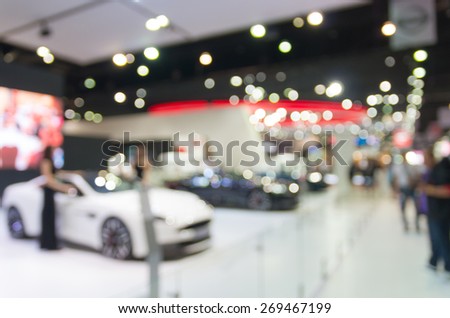 Abstract blurred photo of car show room