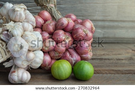 Herbs garlic and lemon on wood