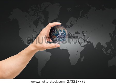 man hand catching the earth on world map,Elements of this image furnished by NASA