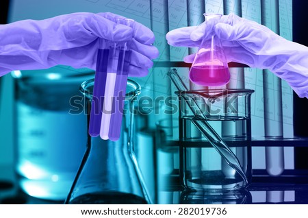 Chemical Laboratory,scientist dropping the reagent into test flask