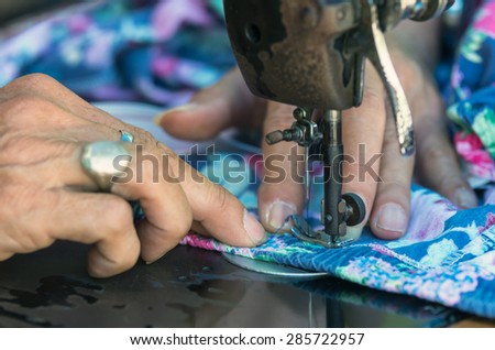 Sewing Process with old man designer hand