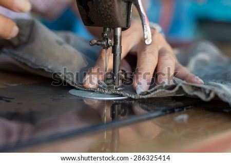 Closeup Sewing Process with old man designer hand