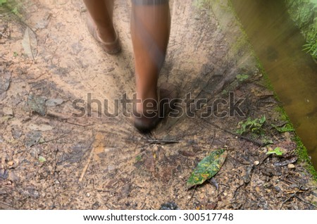 Movement blurred of Hiking boots on trail walking running in the forest. motivational health and travel concept.