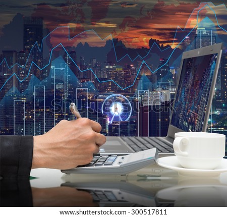 Businessman working with the laptop for earn the usd dollar money on Trading graph on the cityscape at night and world map background,Business financial concept
