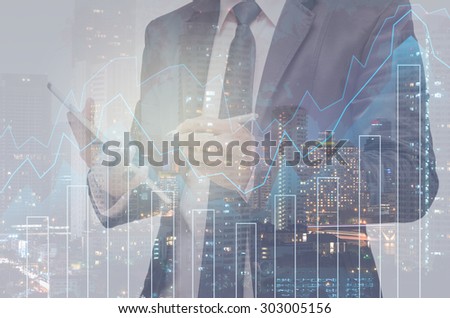 Double exposure of businessman with Trading graph on the cityscape background,Business financial concept