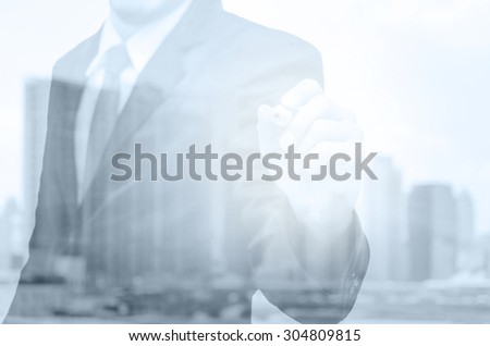 Double exposure of businessman with cityscape building glass