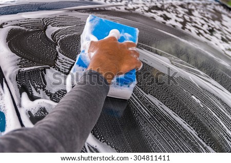 Cleaning the car at car wash shop,car care concept, focus on hand