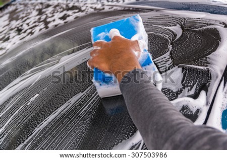 Cleaning the car at car wash shop,car care concept, focus on hand