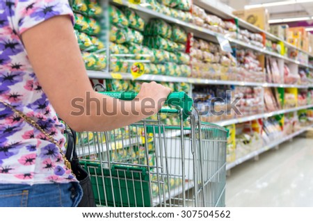 Handing the trolley with store blurred in department store bokeh background