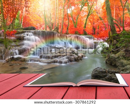 conceptual book image of Beautiful waterfall with soft focus and rainbow in the forest