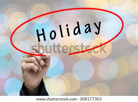 Businessman Hand writing Holiday by pen on screen background. Business concept