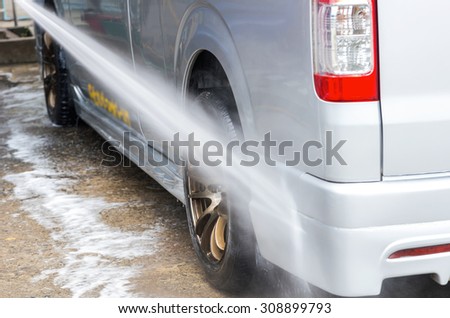 Van Car wash by high pressure cleaners, focus on the car