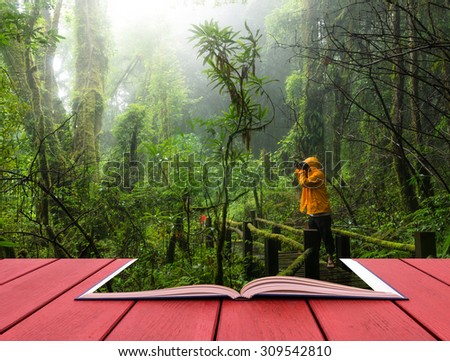 conceptual book image of Traveler taking photo at Beautiful rain forest