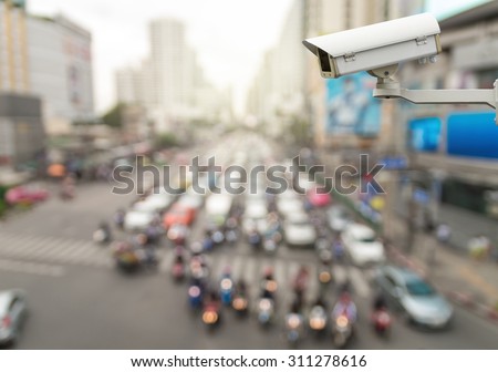 CCTV security camera on abstract Blurred photo of traffic jam with rush hour