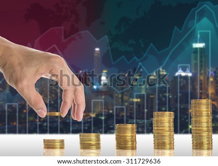 Hand putting the gold coins on the stack of golden coins on Trading graph on the cityscape blurred background, Business financial concept
