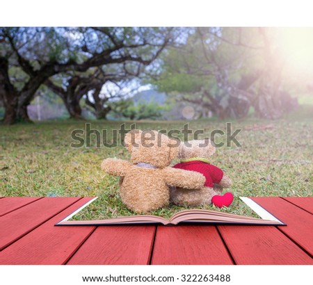 Open book image of Two TEDDY BEAR brown color sitting on grass under the tree with sun ray