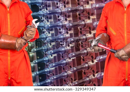 Engineers worker holding the tools on Industrial equipment of PET preforms background, industry concept
