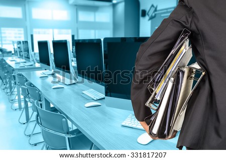 Businessman is holding many document folders on Abstract blurred photo of empty server room, back side, business busy concept