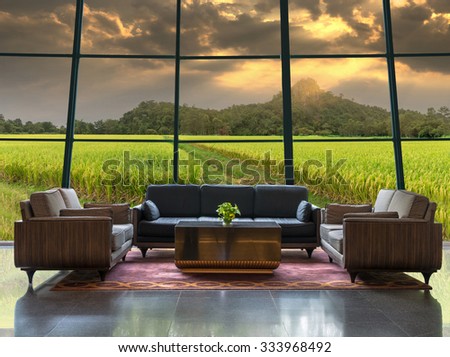 Lobby area of a hotel which can see Rice field with mountain background under fantastic sun light sky