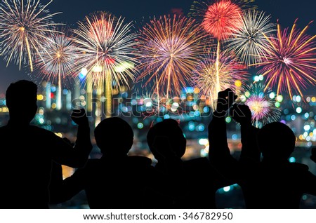 The people looks Fantastic festive new years colorful fireworks on cityscape blurred photo bokeh,project success, holiday concept, family concept